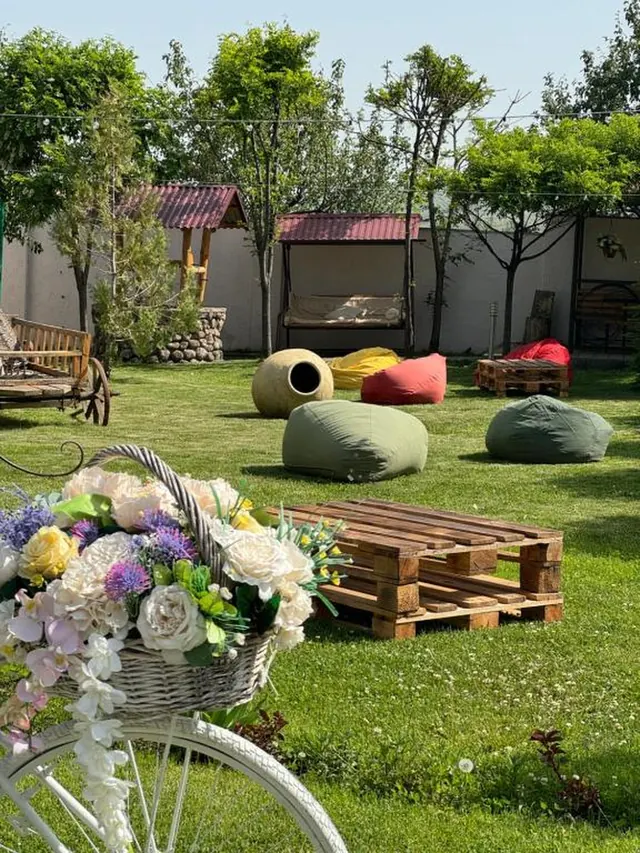 The hotel garden in spring with flowers and bean bags on the lawn