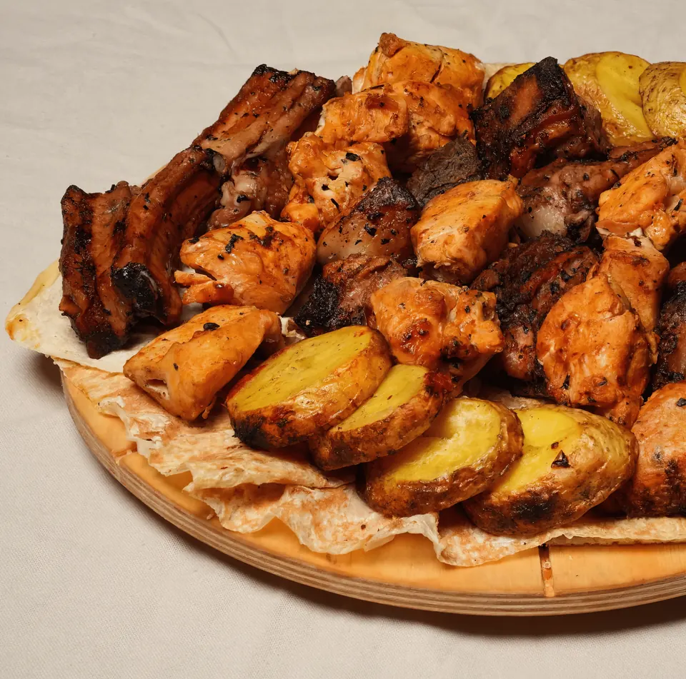 Armenian khorovats barbecue with potatoes on lavash