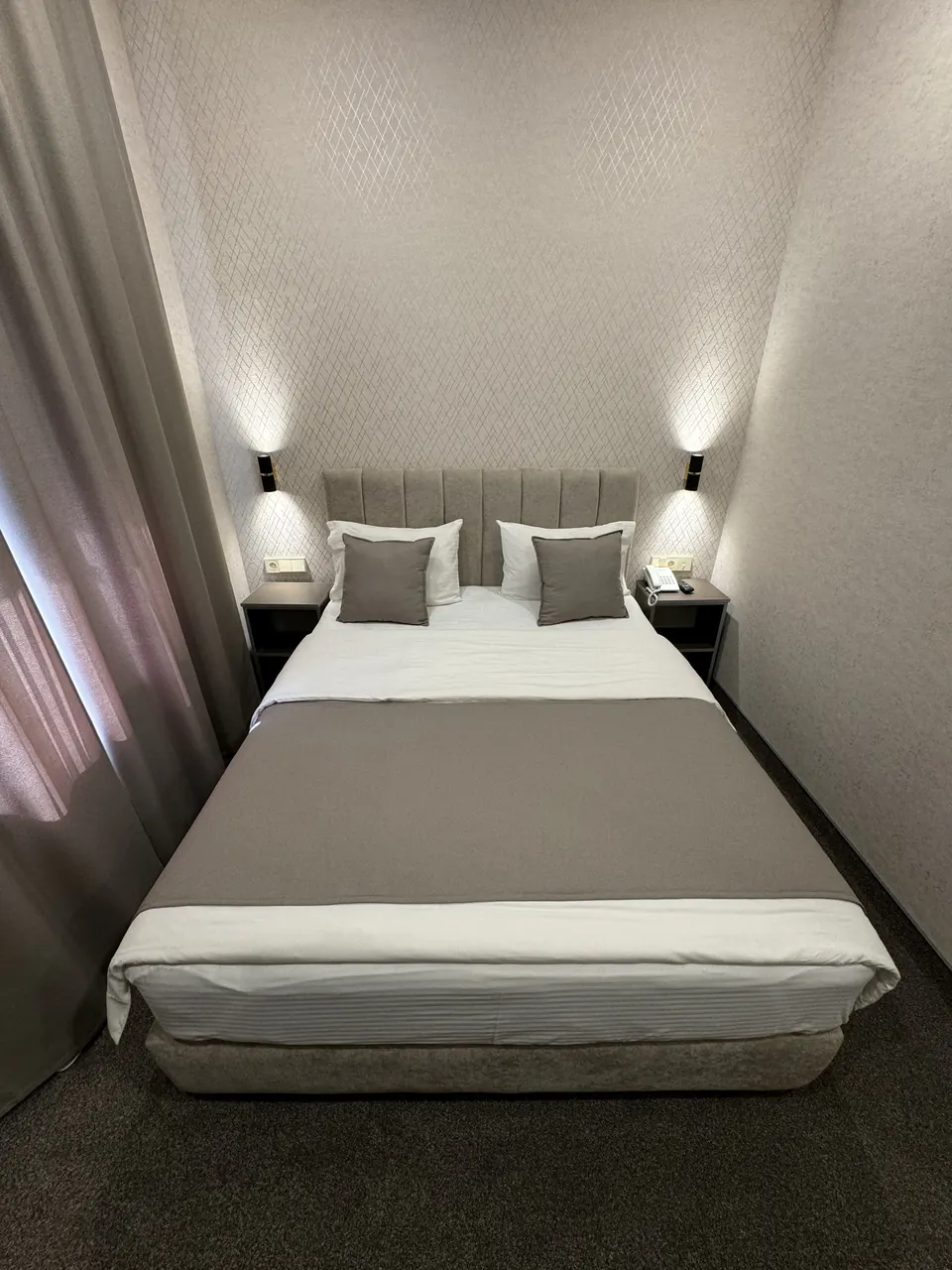 Luxe Room with a double bed and wall lights on either side