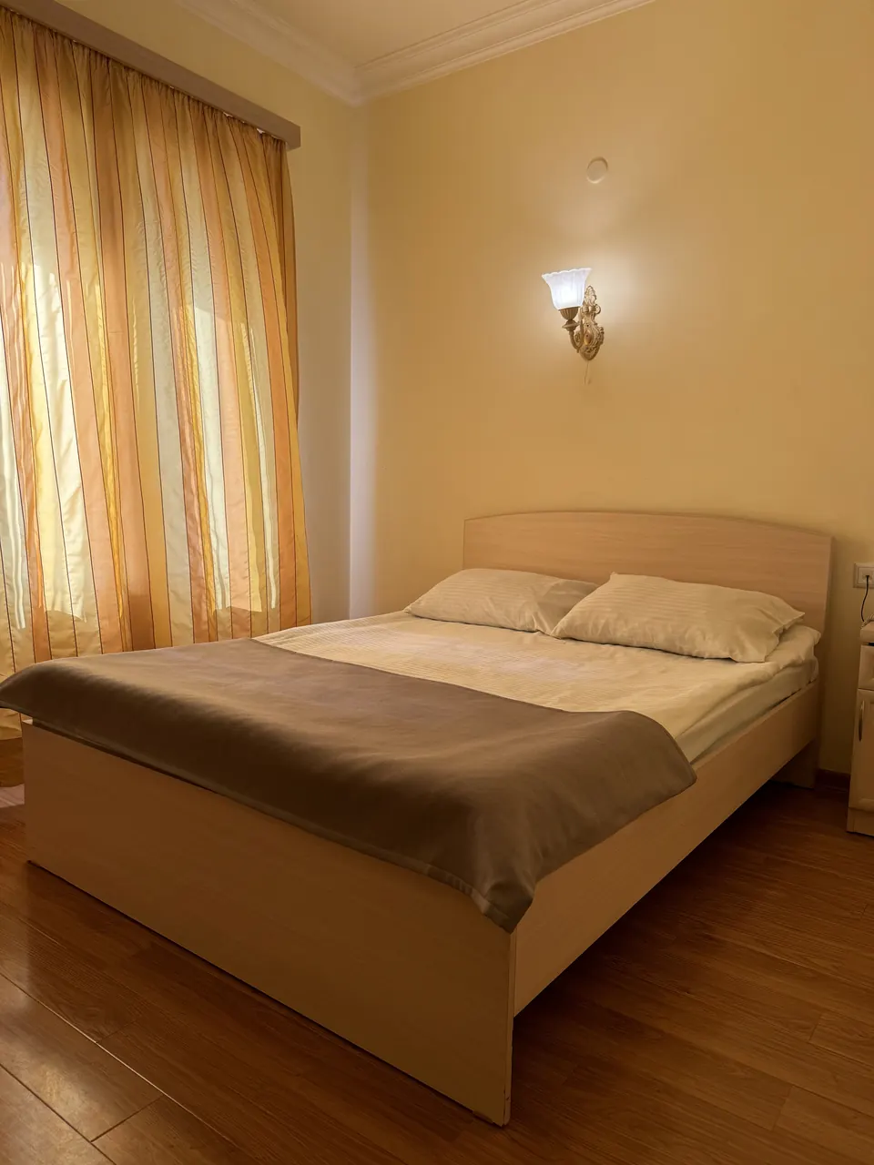 Standard Room with a double bed and warm wall light